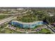 A multi-story blue condominium building is surrounded by lush greenery, palms and parking at 3315 58Th S Ave # 421, St Petersburg, FL 33712