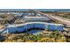 Scenic view of the condo building with a pool and lush landscaping, near the bay and highway at 3315 58Th S Ave # 421, St Petersburg, FL 33712