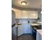 Updated kitchen featuring white cabinets, stone countertops, mosaic backsplash, and stainless steel appliances at 3315 58Th S Ave # 421, St Petersburg, FL 33712
