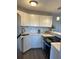 Updated kitchen featuring white cabinets, stone countertops, mosaic backsplash, and stainless steel appliances at 3315 58Th S Ave # 421, St Petersburg, FL 33712