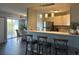 Modern kitchen with breakfast bar, stainless steel refrigerator, pendant lighting, and dining area at 3315 58Th S Ave # 421, St Petersburg, FL 33712