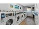 Community laundry room featuring rows of washing machines, ensuring convenient laundry facilities at 3315 58Th S Ave # 421, St Petersburg, FL 33712