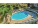 Relaxing community pool area with lounge chairs and a table for residents, surrounded by mature trees at 3315 58Th S Ave # 421, St Petersburg, FL 33712
