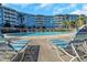 Beautiful pool area with lounge chairs and a building view offering a serene waterfront experience at 3315 58Th S Ave # 421, St Petersburg, FL 33712