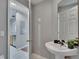 Bathroom with pedestal sink, tiled floor, and updated fixtures at 3455 Castle Stone Ct, Valrico, FL 33594