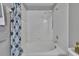 Bright white tiled bathtub and shower combination with brushed nickel fixtures at 3455 Castle Stone Ct, Valrico, FL 33594