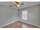 Bedroom with wood-look floors, a ceiling fan, and natural light from the window at 3455 Castle Stone Ct, Valrico, FL 33594