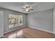 Bright bedroom with wood-look flooring, neutral walls, ceiling fan, and a sunny window at 3455 Castle Stone Ct, Valrico, FL 33594