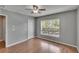 Bright bedroom with modern ceiling fan, hard surface flooring, closet, and large window at 3455 Castle Stone Ct, Valrico, FL 33594