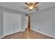 Bedroom with wood-look floors, closet doors, and natural light at 3455 Castle Stone Ct, Valrico, FL 33594