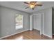 Bedroom with wood-look floors and a closet, featuring natural light from the window at 3455 Castle Stone Ct, Valrico, FL 33594