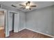 Bedroom featuring wood-look floors, a ceiling fan, and a closet, with natural light at 3455 Castle Stone Ct, Valrico, FL 33594