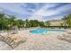 Beautiful community pool surrounded by lounge chairs and lush greenery, offering a relaxing and inviting atmosphere at 3455 Castle Stone Ct, Valrico, FL 33594