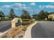 Kings Mill Townhomes community sign with tidy landscaping and signage, situated along a curved roadway at 3455 Castle Stone Ct, Valrico, FL 33594