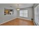 View of dining room with wood floors, pendant lighting, and natural light at 3455 Castle Stone Ct, Valrico, FL 33594