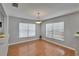 View of a dining room featuring wood floors and a modern light fixture at 3455 Castle Stone Ct, Valrico, FL 33594
