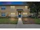 Charming two-story condo featuring a stucco facade, a blue front door, and a well-maintained landscaped yard at 3455 Castle Stone Ct, Valrico, FL 33594