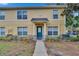 Charming two-story condo featuring a stucco facade, a blue front door, and a well-maintained landscaped yard at 3455 Castle Stone Ct, Valrico, FL 33594