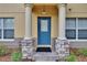 Inviting front door with decorative columns and stone accents for a touch of elegance and curb appeal at 3455 Castle Stone Ct, Valrico, FL 33594