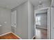 Hallway with wood-look flooring leading to a room with natural light from the window at 3455 Castle Stone Ct, Valrico, FL 33594