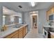 The kitchen provides a view to the living area and access to the half bathroom at 3455 Castle Stone Ct, Valrico, FL 33594