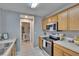 View of the kitchen with modern appliances and a doorway leading to a half bathroom at 3455 Castle Stone Ct, Valrico, FL 33594