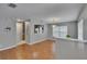 Open-concept living space with wood floors, and access to the kitchen at 3455 Castle Stone Ct, Valrico, FL 33594