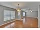 Living area with wood floors, large windows, and contemporary lighting at 3455 Castle Stone Ct, Valrico, FL 33594