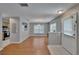 View of open-concept living and dining area with wood floors and natural light at 3455 Castle Stone Ct, Valrico, FL 33594