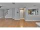 Open-concept living room featuring wood-look flooring, gray walls, stairway to the second floor, and access to the kitchen at 3455 Castle Stone Ct, Valrico, FL 33594
