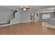 Spacious living room showcasing wood-look floors, a stairway to the second floor, neutral paint, and an open design at 3455 Castle Stone Ct, Valrico, FL 33594