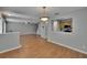 Spacious living room featuring wood floors and an open layout to the kitchen at 3455 Castle Stone Ct, Valrico, FL 33594