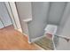 Carpeted staircase with wood-look flooring landing and white trim, leading to a bright hallway at 3455 Castle Stone Ct, Valrico, FL 33594