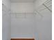 Spacious walk-in closet with white wire shelving and wood-look flooring at 3455 Castle Stone Ct, Valrico, FL 33594