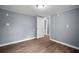 Simple bedroom with wood floors and open doorway at 37732 Cecil Ln, Zephyrhills, FL 33542
