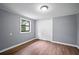 Neat bedroom featuring wood floors, double closet, and a window at 37732 Cecil Ln, Zephyrhills, FL 33542