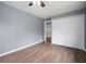 Cozy bedroom with hardwood floors, spacious closet, and neutral color palette at 37732 Cecil Ln, Zephyrhills, FL 33542