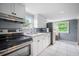 A well-lit kitchen featuring stainless steel appliances and ample countertop space at 37732 Cecil Ln, Zephyrhills, FL 33542