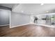Spacious living room featuring an open layout with hardwood floors and gray walls at 37732 Cecil Ln, Zephyrhills, FL 33542
