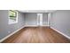 Living room with wood laminate flooring, a bright window, and neutral paint at 37732 Cecil Ln, Zephyrhills, FL 33542