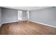 Living room featuring hard wood floors, grey paint, and white trim at 37732 Cecil Ln, Zephyrhills, FL 33542