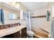 Well-lit bathroom with a modern vanity and tiled walk-in shower at 4076 Mainlands N Blvd, Pinellas Park, FL 33782