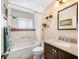 Clean bathroom with a shower-tub combo and vanity with granite countertop at 4076 Mainlands N Blvd, Pinellas Park, FL 33782