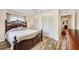 Cozy bedroom featuring a queen bed, wood-look floors and ample closet space at 4076 Mainlands N Blvd, Pinellas Park, FL 33782