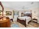Charming bedroom with a queen-size bed, light-colored walls, and natural light at 4076 Mainlands N Blvd, Pinellas Park, FL 33782