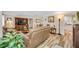 Spacious living room featuring hardwood floors and comfortable leather seating with warm natural light at 4076 Mainlands N Blvd, Pinellas Park, FL 33782