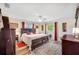 Bright and airy main bedroom with large windows and a plush king-size bed at 4076 Mainlands N Blvd, Pinellas Park, FL 33782
