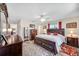 Comfortable main bedroom suite with dark wood furniture and decorative accents at 4076 Mainlands N Blvd, Pinellas Park, FL 33782