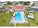 Aerial shot showcasing a large community pool, shuffleboard court, and ample lounging space at 4076 Mainlands N Blvd, Pinellas Park, FL 33782