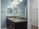 Bathroom featuring a double sink vanity with granite countertops, complementing the modern fixtures and soothing blue walls at 4146 Bexley Village Dr, Land O Lakes, FL 34638